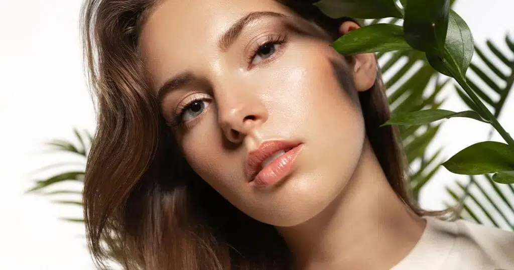Close-up of a woman with smooth, youthful skin and defined facial contours, showcasing natural-looking results of a mini facelift procedure.