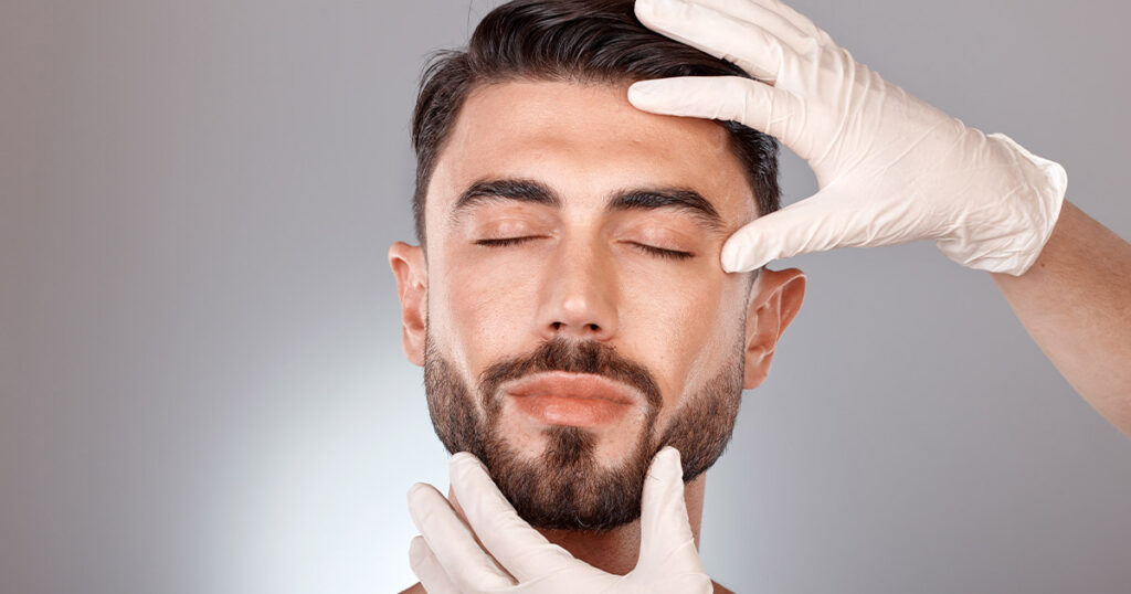 Male patient being examined by a cosmetic specialist before buccal fat removal to enhance facial contour and jawline definition.